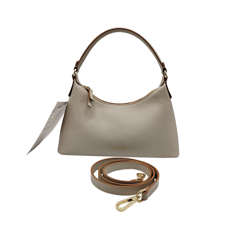 How does a genuine leather women's bag showcase exquisite craftsmanship in its details?